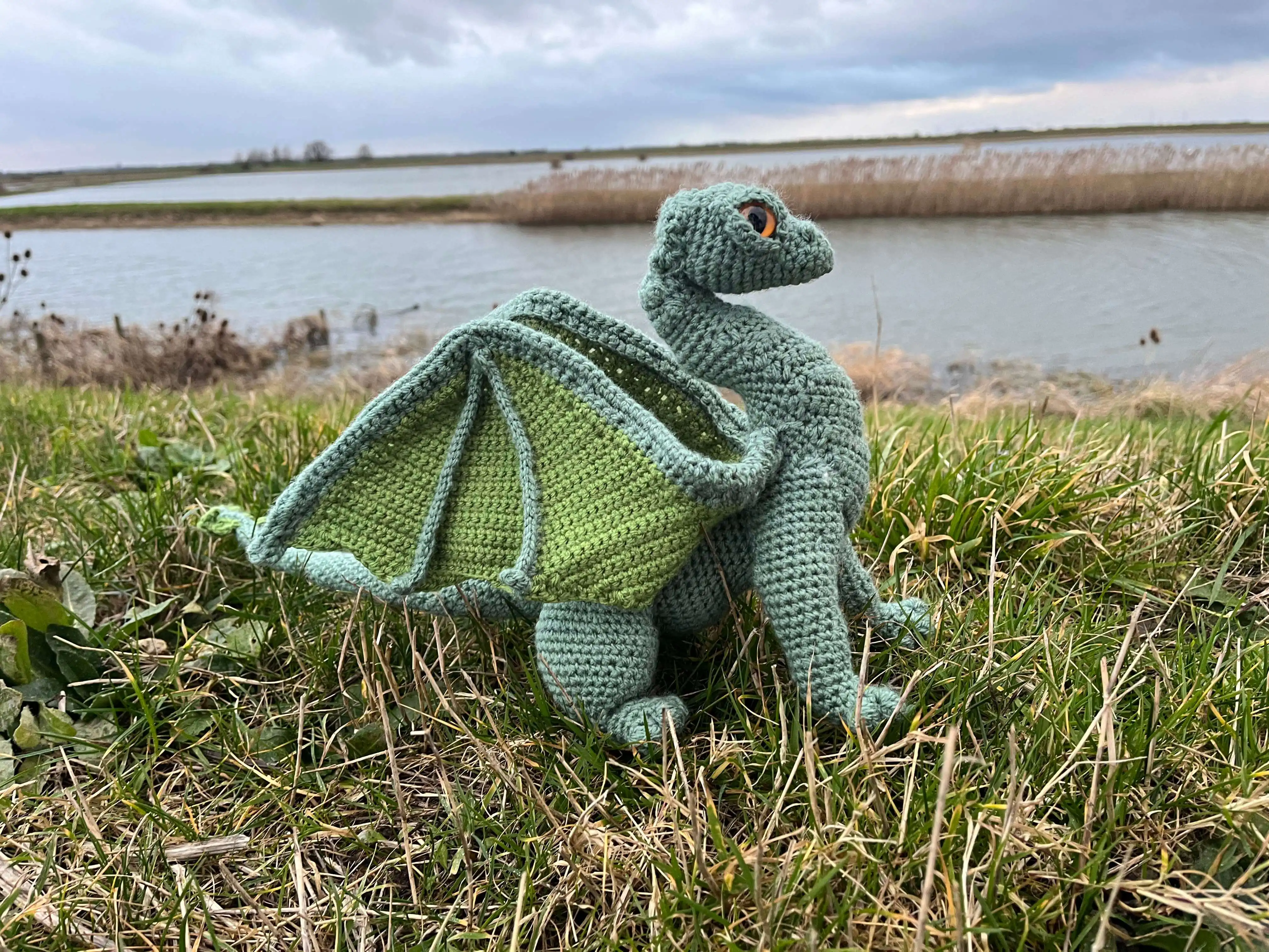 Knitted green dragon soft toy